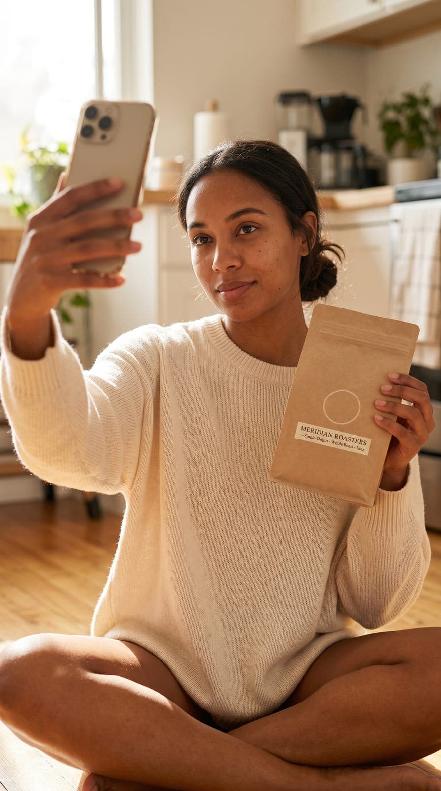 Creator holding a fictional coffee bag (Meridian Roasters) in a sunlit kitchen. UGC demo image.